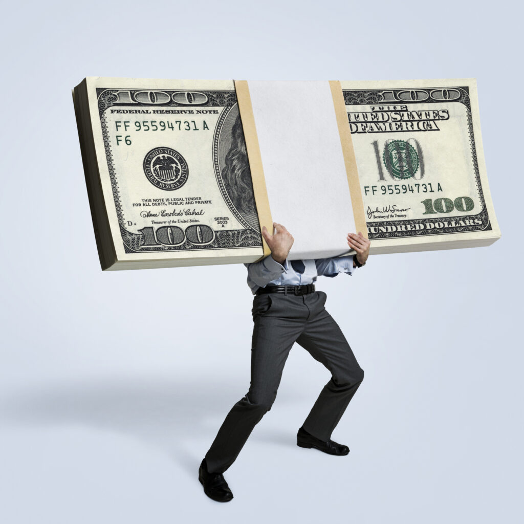 Businessman holding big bundle of money