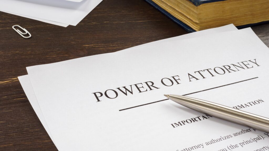 A pen on top of paperwork that says Power of Attorney on it.