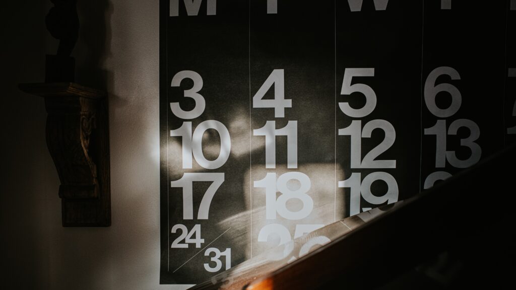 Sunbeams on a wall calendar showing one month.