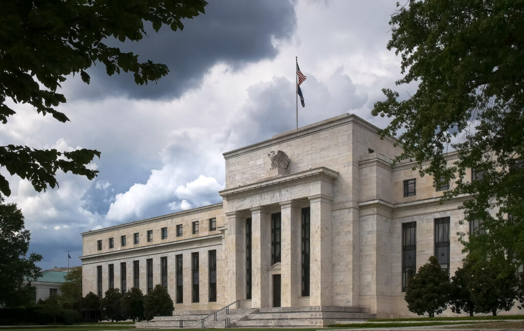 the federal reserve building in washington dc under gathering storm clouds