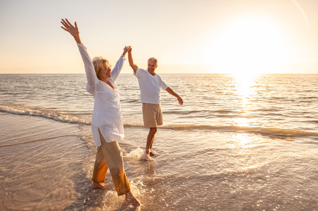 Couple walking on the beach at sunset