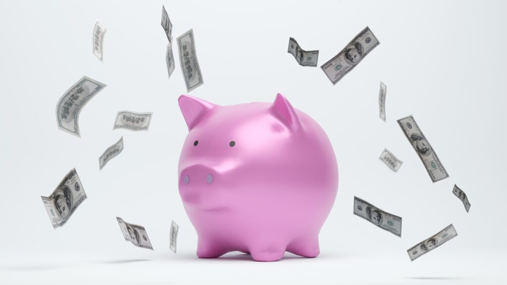 Cash floats around a piggy bank.
