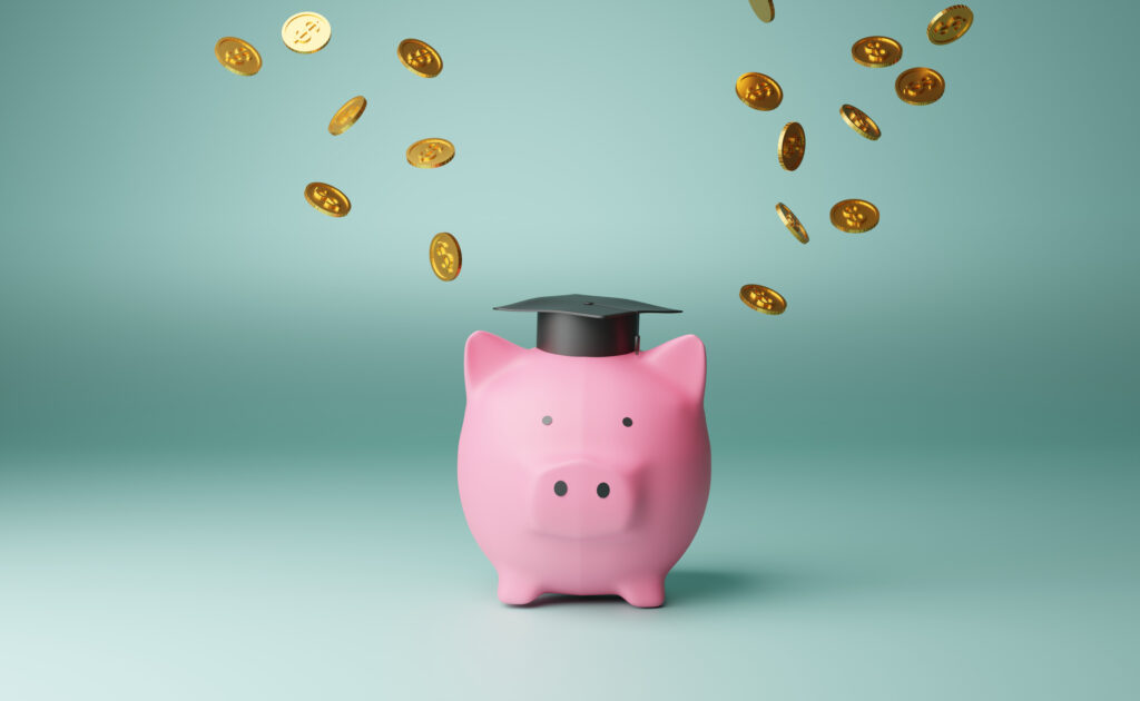 pink piggy bank with grad cap on and coins floating above