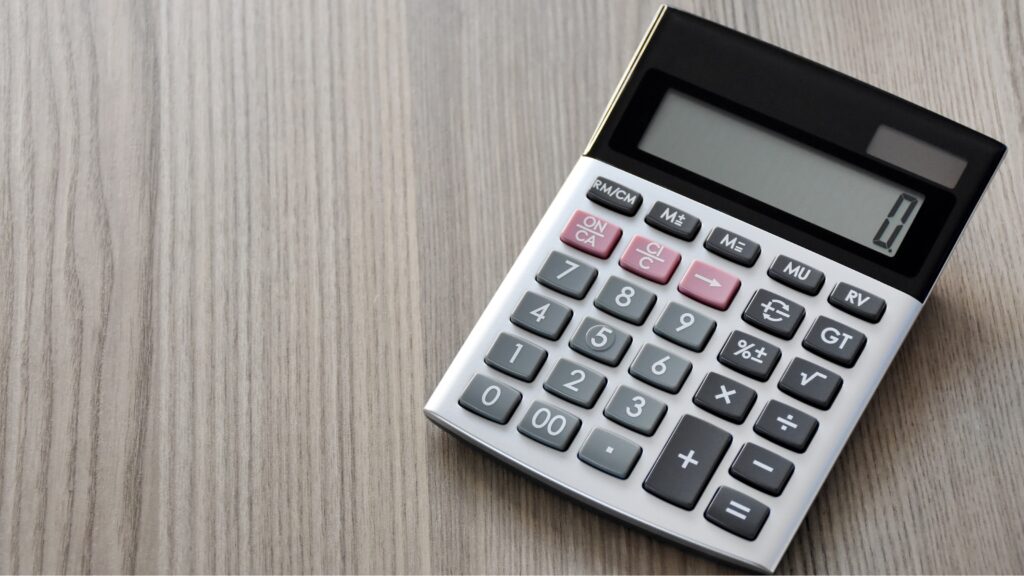A calculator sits on a table.