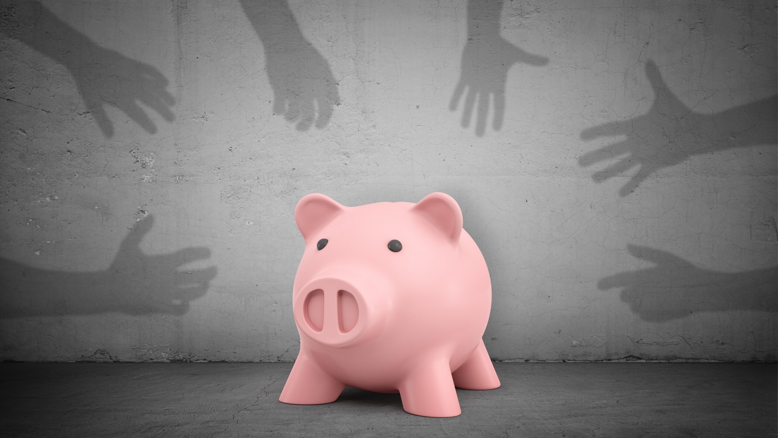 Shadowy hands on a gray background reach for a piggy bank in the middle.
