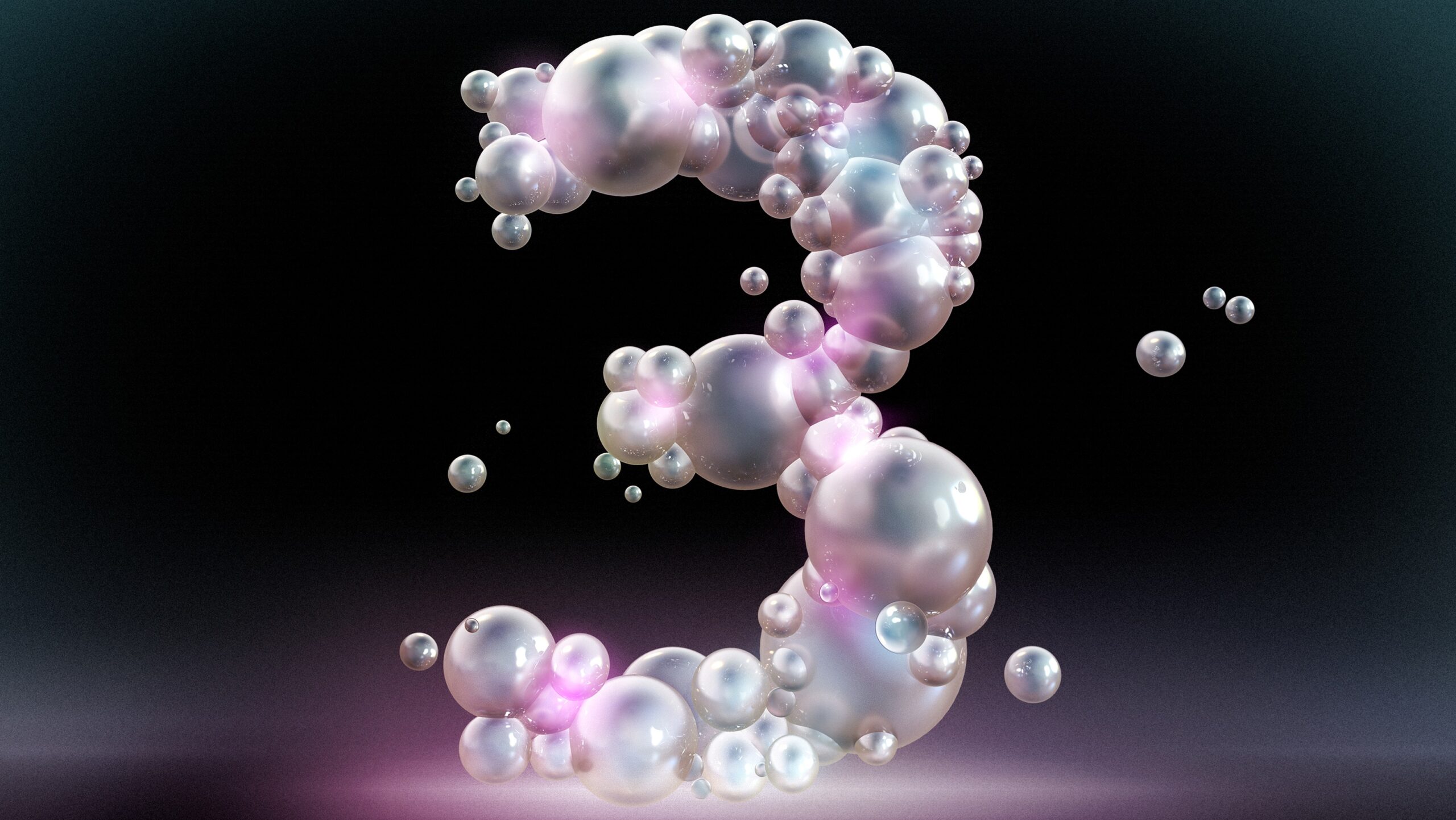 The number three composed of bubbles against a black background.