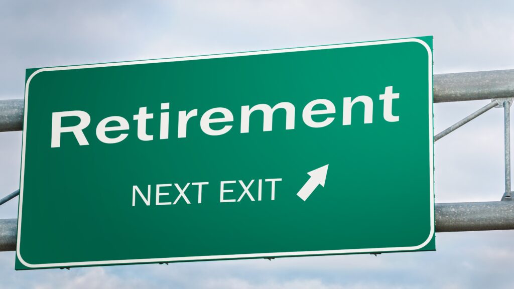 A highway sign says "Retirement Next Exit" with an arrow.