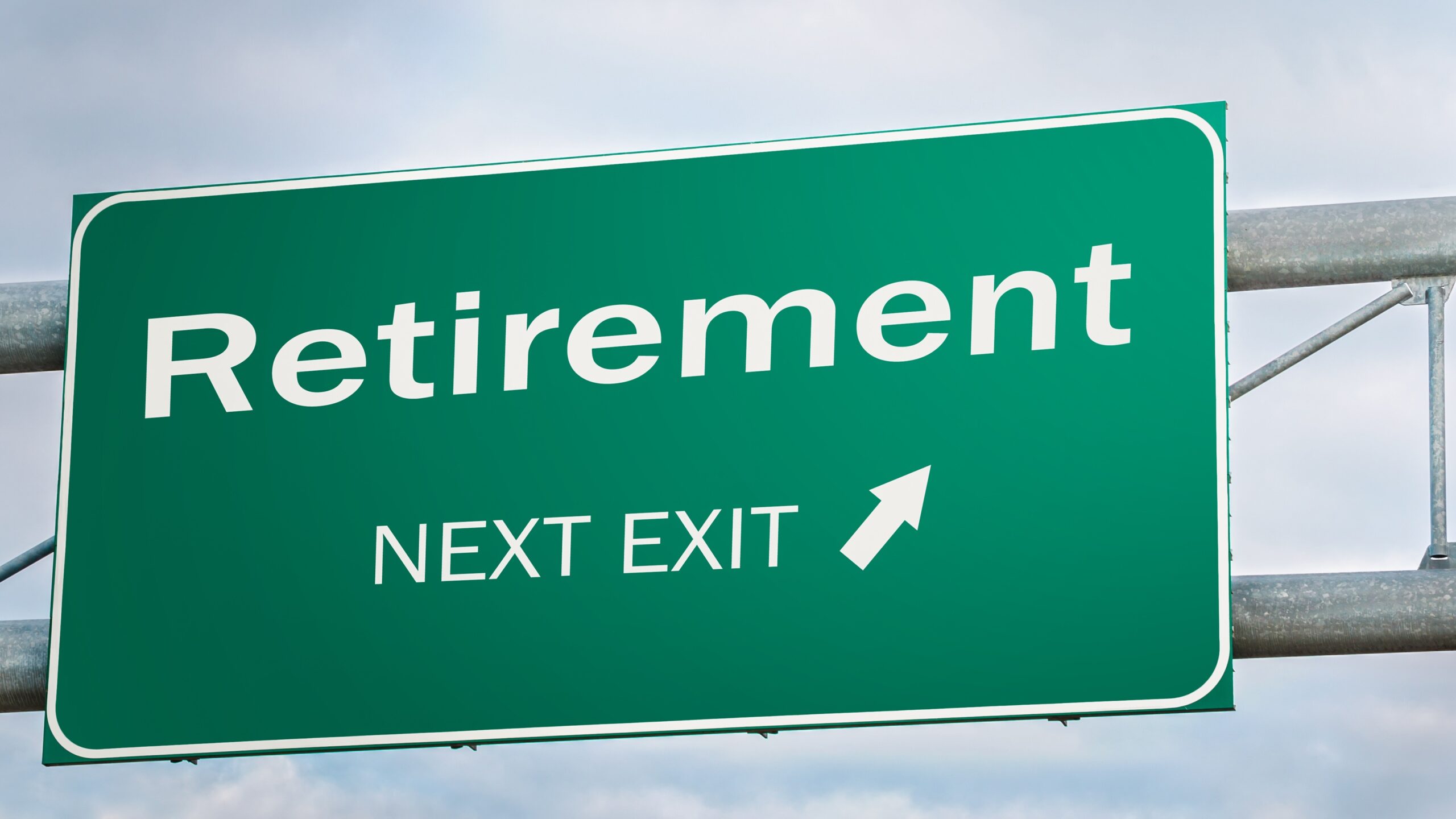 A highway sign says "Retirement Next Exit" with an arrow.