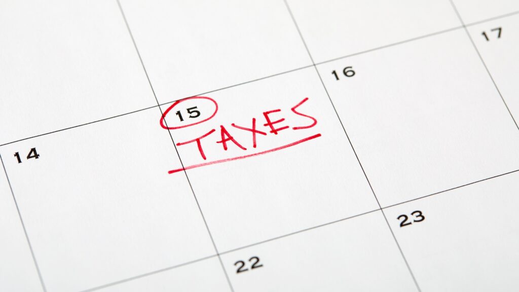 Taxes written in red and underlined on the 15th on a calendar