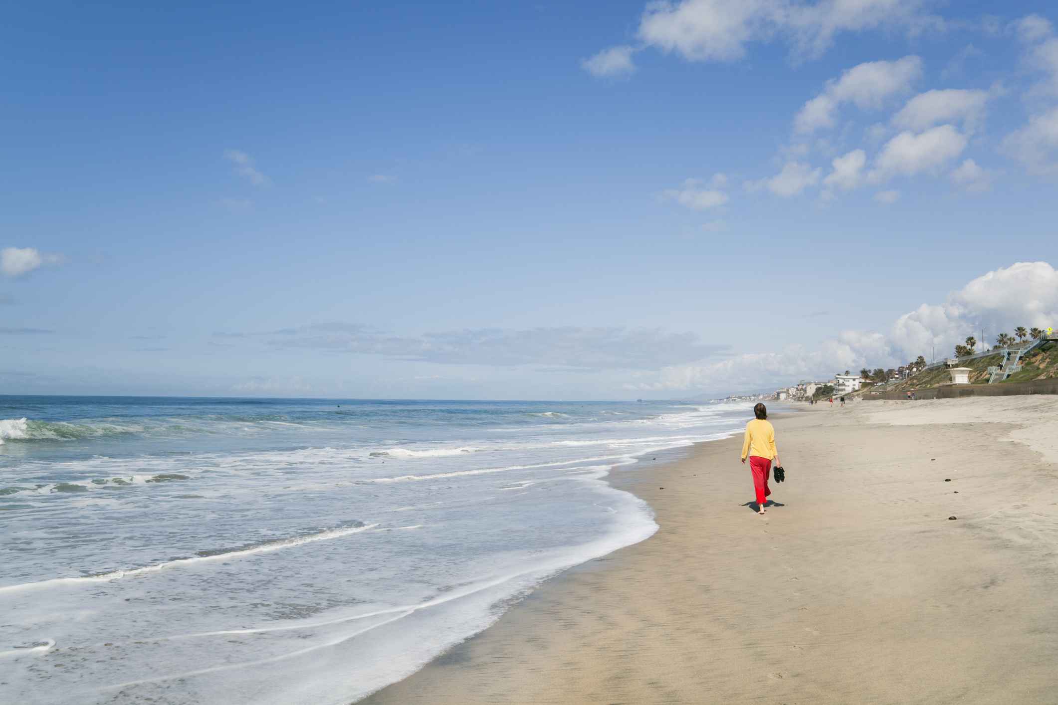 Une femme marchant le long de la plage près de San Diego