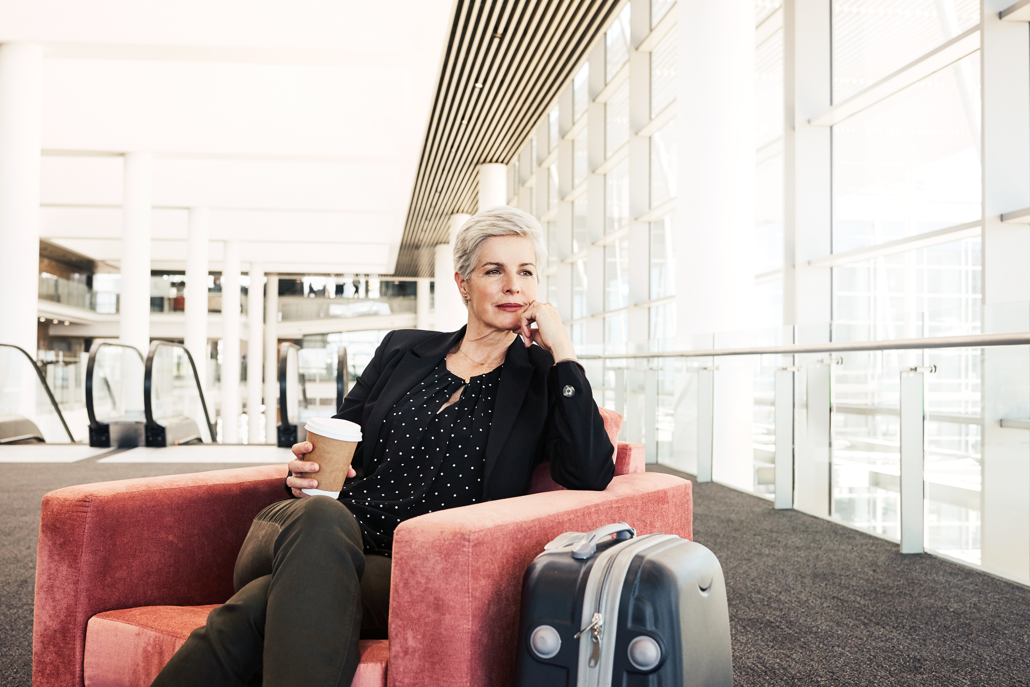 Photo d'une femme d'affaires assise sur une chaise dans un salon d'aéroport