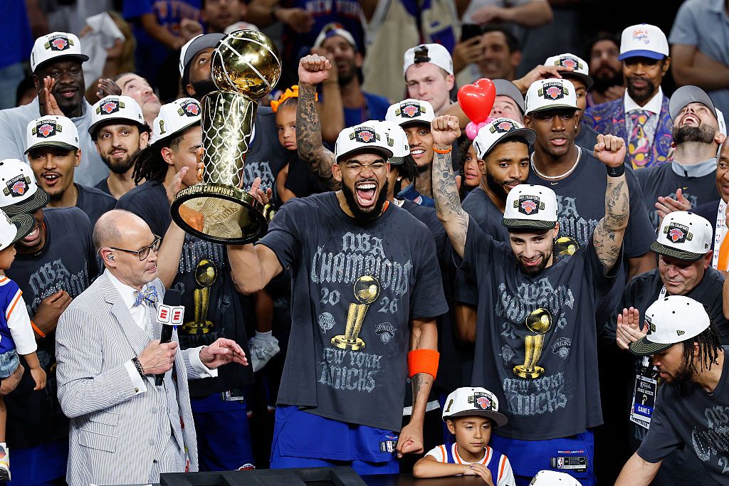 The Knicks celebrate getting the NBA championship trophy.