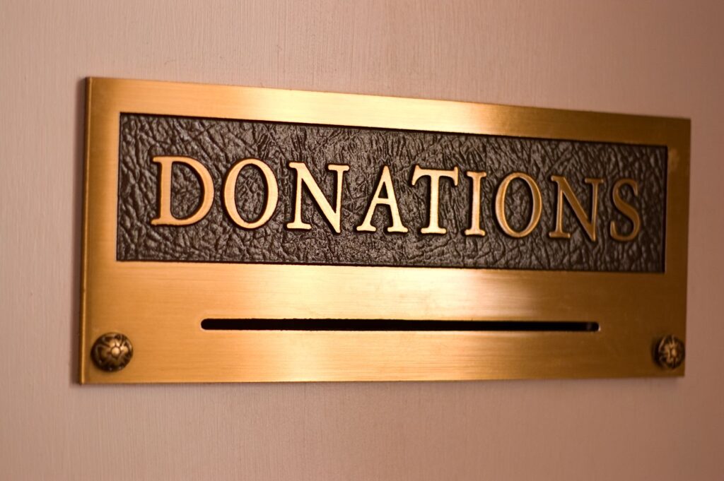 A gold-colored box marked "Donations" on a tan background