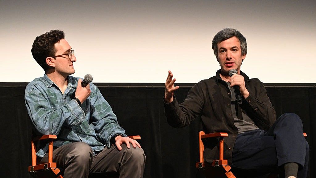 "You Can See Everything" directors Nathan Fielder and Lance Oppenheim sit on directors chairs answering questions with microphones.
